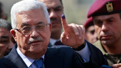 Palestinian leader Mahmoud Abbas shows his ink-stained finger after casting his vote during local elections at a polling station in the West Bank city of Ramallah. Mr Abbas called for legislative elections on May 22 and presidential elections on July 31, 2021. AP