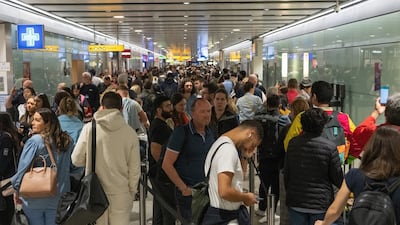 Travellers wait in long queues to pass through security checks at Heathrow airport in London. Getty