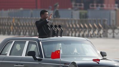 Chinese President Xi Jinping waves as he rides in an open-top limousine. EPA