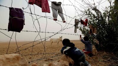 Syrian children look at a donkey from behind the fence at a temporary refugee camp in the village of Ain Issa, housing people who fled ISIL’s Syrian stronghold of Raqa, some 50 kilometres north of the group’s de facto capital on November 10, 2016. The US-backed Syrian Democratic Forces (SDF) said their advance on Raqa was being delayed by a sandstorm. Delil Souleiman / Agence France-Presse