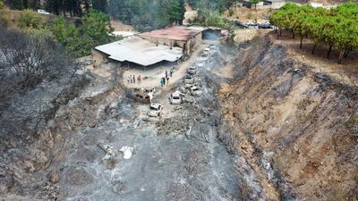 A picture taken with a drone shows an aerial view a row of burnt-out cars at Al Damour area south of Beirut. EPA