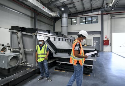 Workers at Tadweer's fallen stock incinerator facility. Khushnum Bhandari / The National