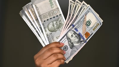 The greenback's slide means it is quickly getting more expensive for expatriates in any country with a currency pegged to the dollar to send money home. AFP