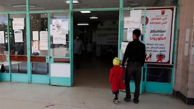 Yemenis pass an anti-coronavirus awareness banner at the entrance to a hospital amid the coronavirus COVID-19 pandemic, in Sanaa. EPA