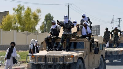 Taliban fighters on Humvee vehicles parade along a road in Kandahar to celebrate after the US pulled all its troops out of Afghanistan. AFP