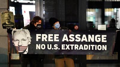 Protesters hold a sign supporting WikiLeaks founder Julian Assange. AFP