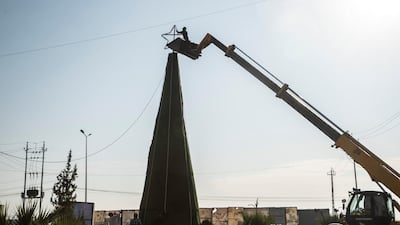 Setting up a Christmas tree outside the town of Hamdaniya, Mosul. Haider Husseini