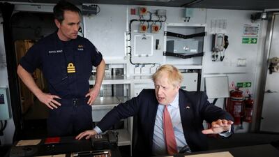 British Prime Minister Boris Johnson sits on the bridge of 'HMS Dauntless', a Type 45 air-defence destroyer of the Royal Navy, during a visit to Cammell Laird shipyard in Liverpool on Thursday. Getty Images