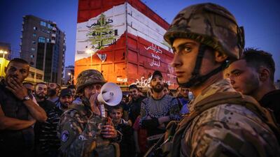 Lebenese soldiers keep watch as several hundred people protest in the northern city of Tripoli on April 17, 2020 despite the country's coronavirus lockdown, marking six months since the country was rocked by mass rallies over government corruption and economic hardships. AFP