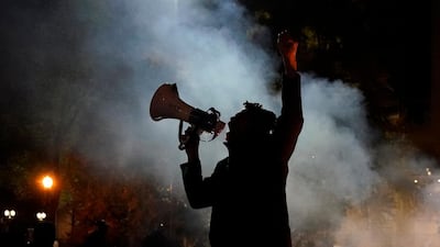 A protester yells after a march to the Mark O. Hatfield United States Courthouse on the night of the election, Oregon. AP Photo
