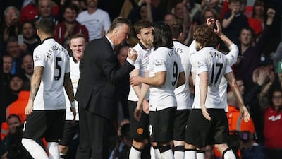 Manchester United manager Louis van Gaal celebrates with his players at full time on Sunday of their 2-1 Premier League win over Liverpool. Phil Noble / Reuters / March 22, 2015