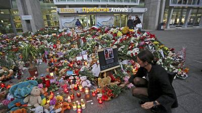 A woman lays flowers at a makeshift memorial outside Pulkovo Airport in St Petersburg for victims of the Russian airliner crash in Egypt, which killed all 224 people on board. Peter Kovalev/Reuters
