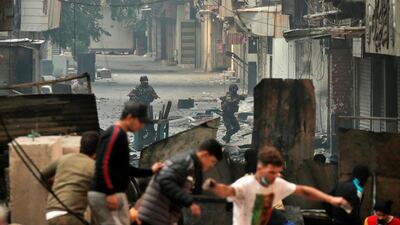 Security forces try to disperse anti-government protesters during clashes in Baghdad. AP Photo