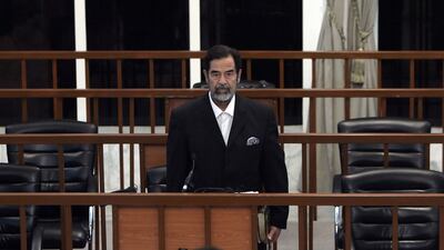Saddam Hussein listens as he receives his verdict during a trial held amid tight security in Baghdad's heavily fortified Green Zone, November 5, 2006. AFP