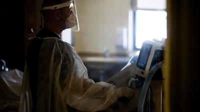A caregiver attends to a Covid-19 patient in an ICU room at the Sharp Chula Vista Medical Center, in Chula Vista, south of San Diego, California. EPA
