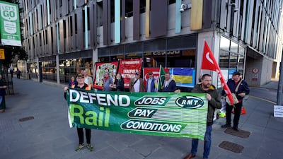 RMT members protest over pay, jobs and conditions outside Nottingham station in central England. PA