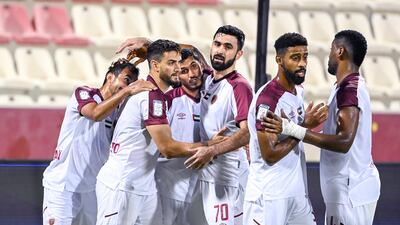 Al Wahda players celebrate during a 4-0 win over Al Arooba.