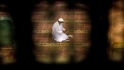 A worker places markers to ensure social distancing to help prevent the spread of the coronavirus at A; Mirabi Mosque in Jeddah. AP