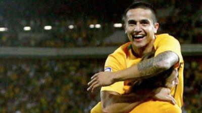Tim Cahill celebrates his Australian team-mate Josh Kennedy after the lanky striker had made it 4-0 against Qatar.