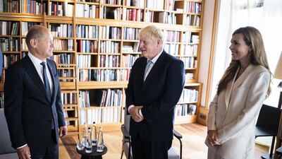 Mr Scholz greets Mr and Mrs Johnson. PA