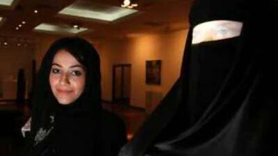 Ala'a al Obaidly poses with her artwork 'The Propagandist' during an exhibition at the Dubai Ladies Club.