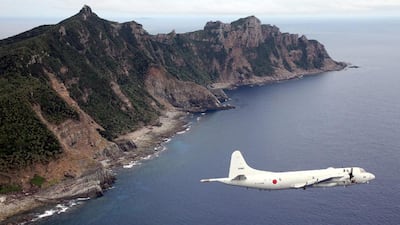 A Japanese Maritime Self-Defense Force plane flies over the disputed islets known as the Senkaku islands in Japan and Diaoyu islands in China. AFP