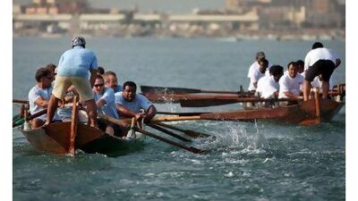 The RAK Free Trade Zone rowers, right, compete with the Al Shaheen team yesterday.