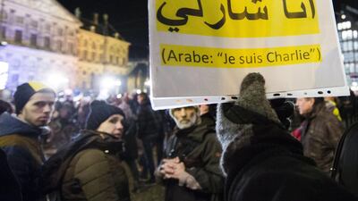 A sign in Arabic states ‘I am Charlie’ at Dam Square as crowd gather in support of the victims after the terrorist attack in Paris on January 8, 2015 in Amsterdam, The Netherlands. Twelve people were killed, including two police officers, as two gunmen opened fire at the offices of the French satirical publication Charlie Hebdo. Michel Porro / Getty Images