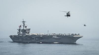 Helicopters fly from the aircraft carrier USS Theodore Roosevelt during a vertical replenishment with the aircraft carrier USS Carl Vinson in the Gulf of Oman. US Navy Media Content Services / AP Photo