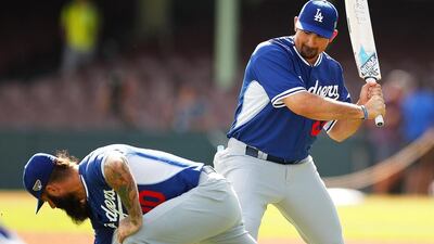 Adrian Gonzalez of the Los Angeles Dodgers plays around with a cricket bat with teammate Brian Wilson at a training session at Sydney Cricket Ground on Tuesday. Brendon Thorne / Getty Images / March 18, 2014