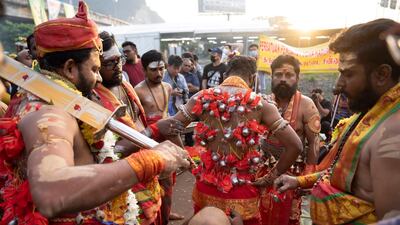 A Hindu devotee with hooks embedded into his back before taking part in a procession during the Thaipusam festival at Batu Caves, outskirts of Kuala Lumpur, Saturday, Feb. 8, 2020. AP