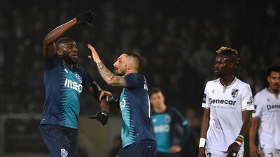Porto's Moussa Marega, left, attempts to leave the pitch after racist insults by Vitoria de Guimaraes fans. EPA