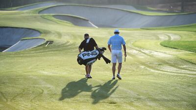 Lee Westwood of England walks with caddie Billy Foster. There are effectively two main prizes on offer this week: the DP World Tour Championship title and the Race to Dubai crown. Ross Kinnaird / Getty Images
