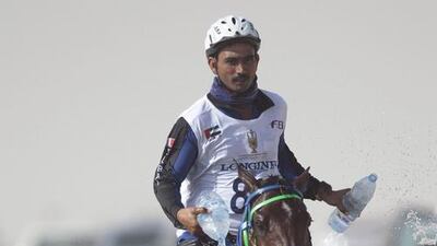 Aaftab Khan of Al Shababi Endurance Stables cools down his mount Vicente during the race.