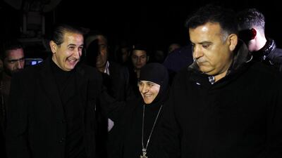 Head of the Mar Thecla monastery in Maloula, Mother Pelagia Sayyaf, who was freed with other nuns after being held by rebels for more than three months, walks with head of Lebanese general security, Maj Gen Abbas Ibrahim, right, after her arrival at the Syrian border with Lebanon at the Jdidat Yabbous crossing on March 10, 2014. Khaled Al Hariri / Reuters