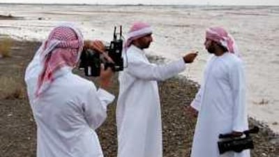 Storm chaser Omar al Naimi, centre, has a website with 15,000 members and has a regular programme on Al Dafrah TV.