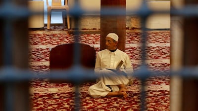 A man reads Muslims holy book the Quran at Al Shafi mosque in Jeddah's Old City, Saudi Arabia. AP Photo