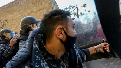 Lebanese policemen and students at the American University of Beirut (AUB) clash during a protest in front of the university over an effective tuition fee hike caused by the changing of the exchange rate from Lebanese lira to US dollar. EPA