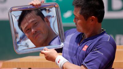 Japan's Shingo Kunieda celebrates with trophy after winning the men's wheelchair tennis final against Argentina's Gustavo Fernandez at the French Open in Paris. Reuters