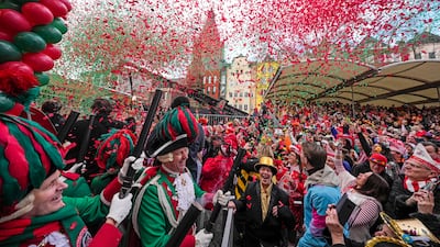 Revellers celebrate the start of the street carnival at the Alter Markt in Cologne, Germany. AP