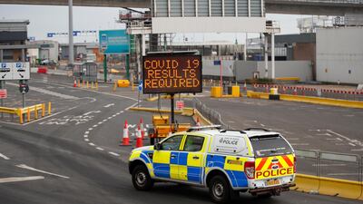 A police car drives past an information sign at the entrance to the Port of Dover. Reuters