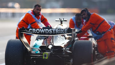 Marshals move the stricken Mercedes of George Russell after the British driver suffered engine failure near the end of the race. Getty Images