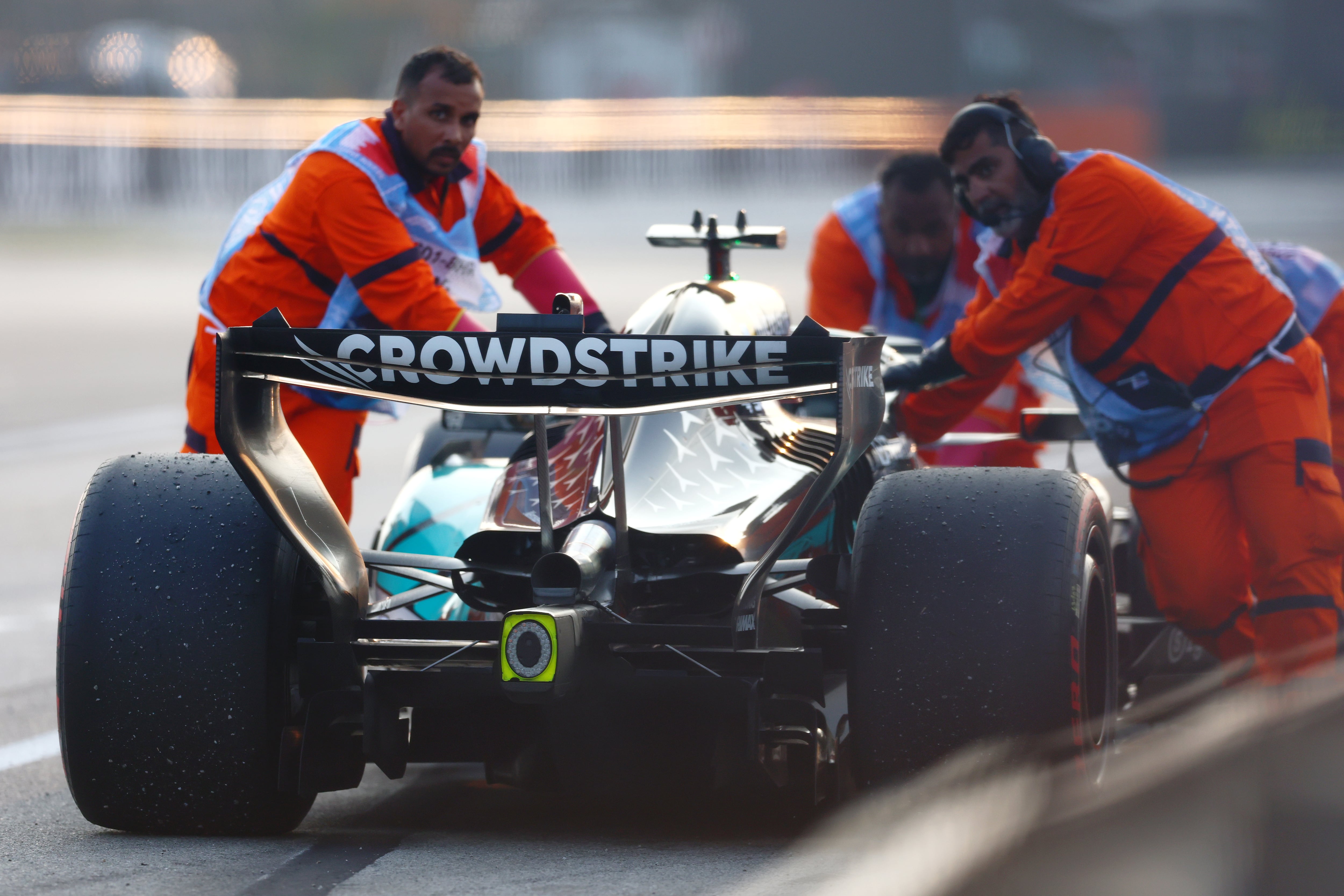 Marshals move the stricken Mercedes of George Russell after the British driver suffered engine failure near the end of the race. Getty Images