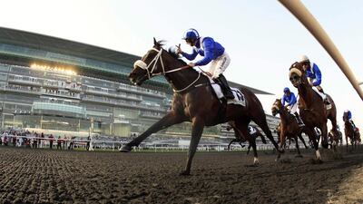 Paul Hanagan, riding Soft Falling Rain of South Africa, races past the finish line to win the second race Godolphin Mile during the Dubai World Cup at the Meydan Racecourse in Dubai. Ahmed Jadallah/Reuters