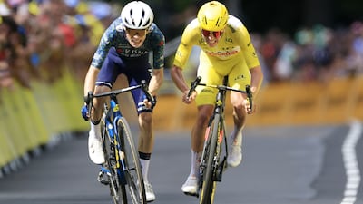 Danish rider Jonas Vingegaard, left, of Team Visma-Lease a Bike fights to cross the finish line ahead of yellow jersey rider Tadej Pogacar of UAE Team Emirates to win the 11th stage of the 2024 Tour de France. EPA