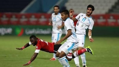 ABU DHABI , UNITED ARAB EMIRATES - April 15 , 2013 : Ismaeel Al Hamadi ( no 7 in red ) of Al Ahli and Mohammed Fawzi ( no 8 in white ) of Bani Yas in action during the Etisalat Pro - League football match between Bani Yas vs Al Ahli at Baniyas stadium in Abu Dhabi. ( Pawan Singh / The National ) For Sports