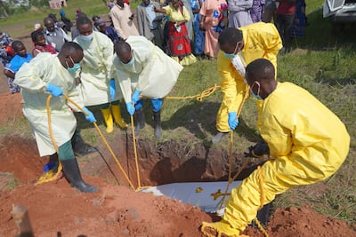 Health workers bury a patient who died from Ebola in Ituri province, in the DRC. EPA