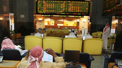 Above, traders at the Abu Dhabi Securities Exchange monitor the movement of stocks. Delores Johnson / The National