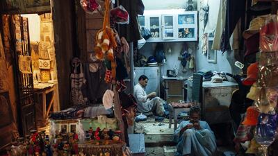 Egyptian shopkeepers sit at their shops in the tourist market in central Luxor. Postrevolutionary Egyptian governments have dithered over ending unaffordable subsidies. Ed Giles / Getty Images