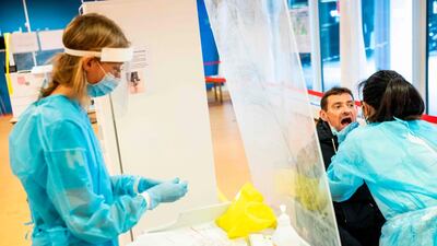 Medical staff members take a samples from a patient to test him for the novel coronavirus on May 6, Herlev Hospital, Copenhagen, Denmark. Ritzau Scanpix / Ólafur Steinar Gestsson / AFP